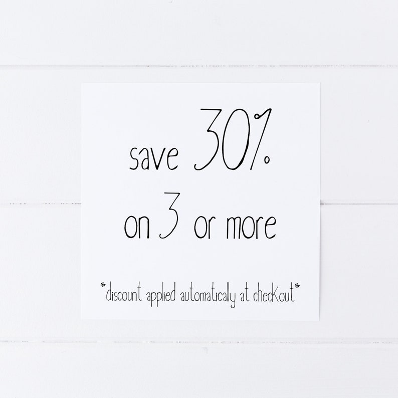 May include: A white sign with black text that reads "save 30% on 3 or more *discount applied automatically at checkout*"