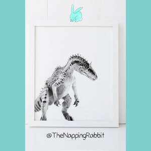 May include: Black and white photograph of a dinosaur in a white frame. The dinosaur is standing on a white background. The image is captioned with "@TheNappingRabbit".