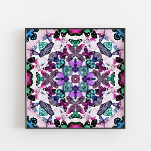 May include: A square framed print featuring a colorful mandala design made of butterfly wings. The wings are arranged in a circular pattern with shades of pink, purple, blue, and green.