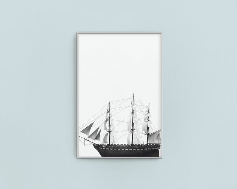 May include: A black and white illustration of a sailing ship with billowing sails against a white background. The ship is framed in a silver frame.