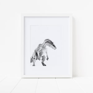 May include: Black and white photo of a dinosaur in a white frame. The dinosaur is standing on a white background.