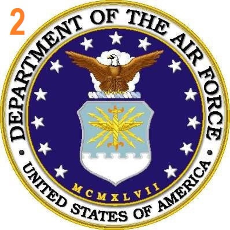May include: A blue and gold seal with the words "Department of the Air Force, United States of America" and a bald eagle with outstretched wings. The seal also includes a shield with a lightning bolt design and the year "MCMXLVII".