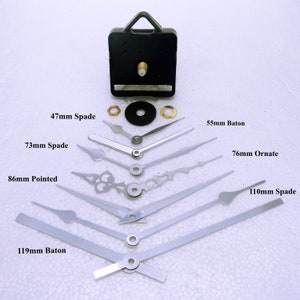 May include: A set of clock hands in various styles and sizes, including spade, baton, and ornate designs. The hands are made of metal and range in length from 47mm to 119mm. The set also includes a clock movement with a black plastic housing.