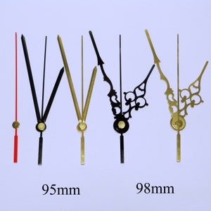 May include: Five clock hands, two gold and three black, with different styles. The gold hands are 95mm long and the black hands are 98mm long.