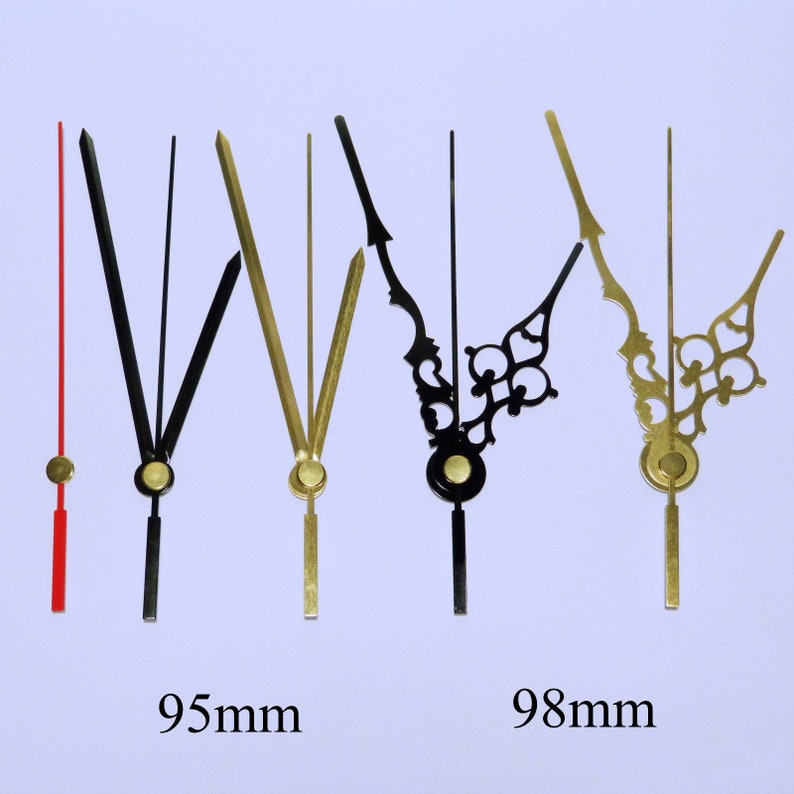 May include: Five clock hands, two gold and three black, with different styles. The gold hands are 95mm long and the black hands are 98mm long.