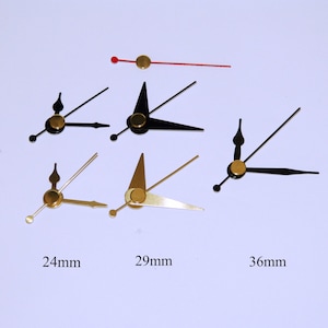 May include: Three sets of clock hands in different sizes: 24mm, 29mm, and 36mm. The hands are gold-colored and black, with a pointed design.