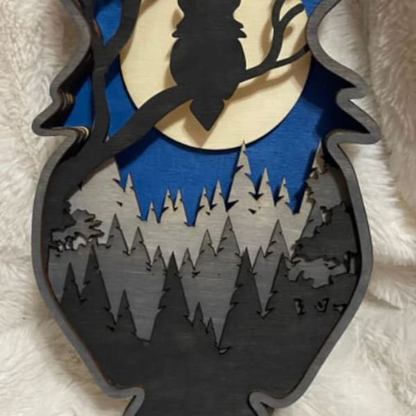 May include: A black owl silhouette perched on a branch in front of a full moon, with a layered forest scene below. The moon is white with a blue background, and the forest is a gradient of gray and black.