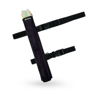 May include: Black carrying case with the text "daftboy" on the top left. The case is designed to hold items and has two black adjustable straps with plastic buckles. The case is filled with multiple items, including wooden sticks and green and white striped items.