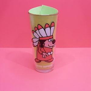 May include: A clear glass with a cartoon graphic of a gopher wearing a Native American headdress. The gopher is in a red outfit with white and red feathers. The glass has the text "Go-Go Gophers" at the bottom.