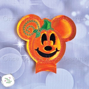May include: Orange pumpkin-shaped Mickey Mouse head with a green stem and black eyes. The face is smiling with a black nose and mouth.