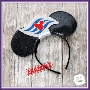 May include: Black glitter mouse ears with a white, blue, and red Mickey Mouse head and wave design. The ears are attached to a black headband. The text "EXAMPLE" is stamped in red on the headband.