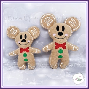May include: Two gingerbread mouse plush toys. The larger mouse is brown with white icing details, red bow tie, and green buttons. The smaller mouse is the same design but smaller. Both are standing on a white background.