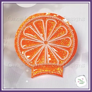 May include: Orange glitter iron-on patch with a white embroidered orange slice design. The patch has a Mickey Mouse ear shape at the bottom.