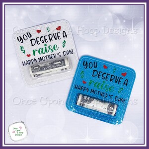 May include: Two square cards with a clear plastic window to hold cash. The cards are decorated with glitter and the text "You deserve a raise Happy Mother's Day!" One card is white with green text and red hearts. The other card is blue with green text and red hearts.