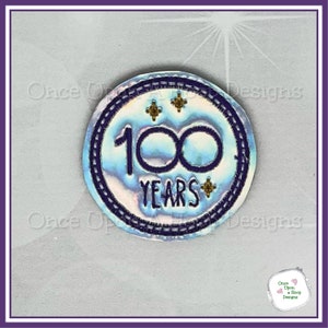 May include: A white iridescent circle with a purple border and the text "100 YEARS" in purple. There are three gold stars inside the circle.