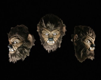 May include: Three werewolf masks, each showing a different angle of the face. The masks are made of brown fur and have realistic features, including sharp teeth and glowing eyes.