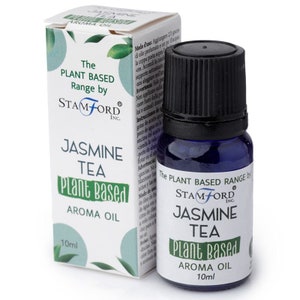 May include: A blue glass bottle with a black cap containing Jasmine Tea Plant Based Aroma Oil. The bottle is labeled with the text "The Plant Based Range by Stamford Inc. Jasmine Tea Plant Based Aroma Oil 10ml".