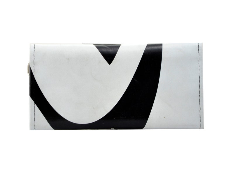 May include: A white wallet with a black abstract design. The wallet has a flap closure and a silver snap.