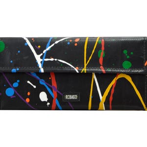 May include: Black wallet with a colourful paint splatter design. The wallet has a small logo that says "REBAGo".