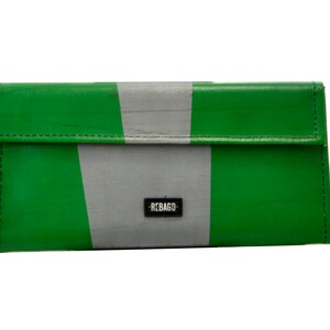 May include: A green and grey striped wallet with the word "REBAGGO" printed on the front.
