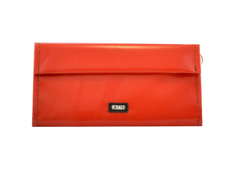 May include: A bright red wallet with a black "REBAGO" label.