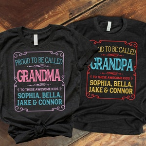 May include: Two black t-shirts with white text. The left shirt says "Proud to be called Grandma to these awesome kids Sophia, Bella, Jake & Connor". The right shirt says "Proud to be called Grandpa to these awesome kids Sophia, Bella, Jake & Connor".
