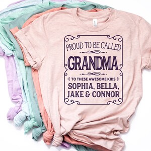 May include: A pink t-shirt with a white graphic that says "Proud to be called Grandma to these awesome kids Sophia, Bella, Jake & Connor".