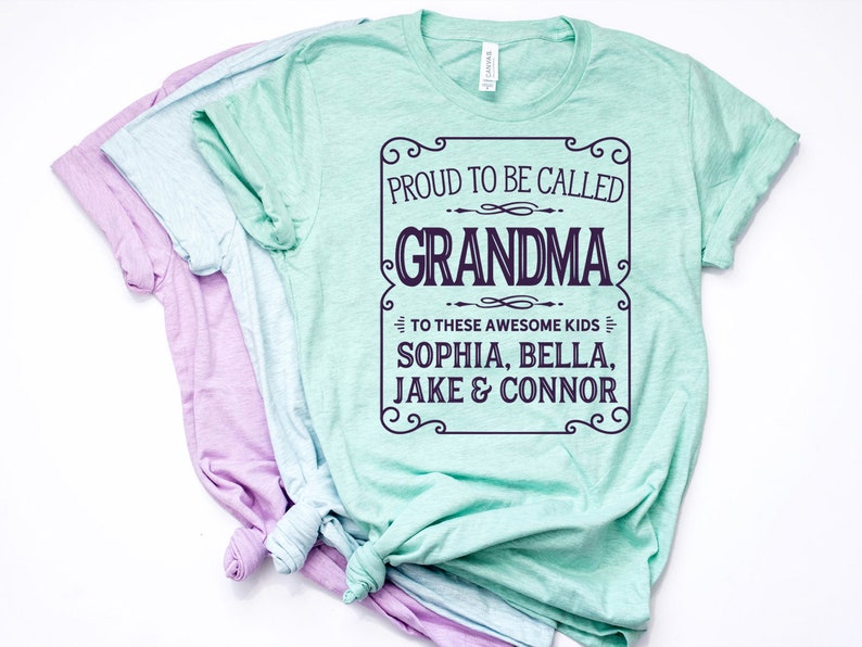 May include: A light green t-shirt with a white text overlay that reads "Proud to be called Grandma to these awesome kids Sophia, Bella, Jake & Connor".