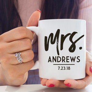 May include: White ceramic mug with black text that reads "Mrs. Andrews 7.23.18".