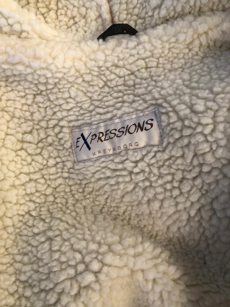 May include: White faux fur lining with a white label that reads "EXPRESSIONS KREYMBORG" in black text.