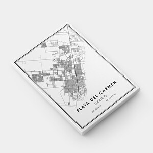 May include: A black and white map of Playa del Carmen, Mexico, printed on a white canvas. The map details the city's layout, with the text "PLAYA DEL CARMEN MEXICO" and coordinates 20.6296&deg;N 87.0739&deg;W.
