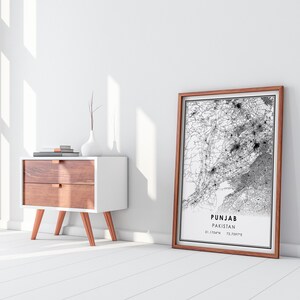 May include: A framed black and white map of Punjab, Pakistan, with the text "Punjab Pakistan 31.1704&deg;N 72.7097&deg;E" printed below the map.