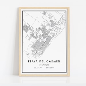 May include: A framed black and white map print of Playa del Carmen, Mexico. The map details the city's layout with streets and buildings. The text "PLAYA DEL CARMEN MEXICO" is centered at the bottom, with coordinates below.
