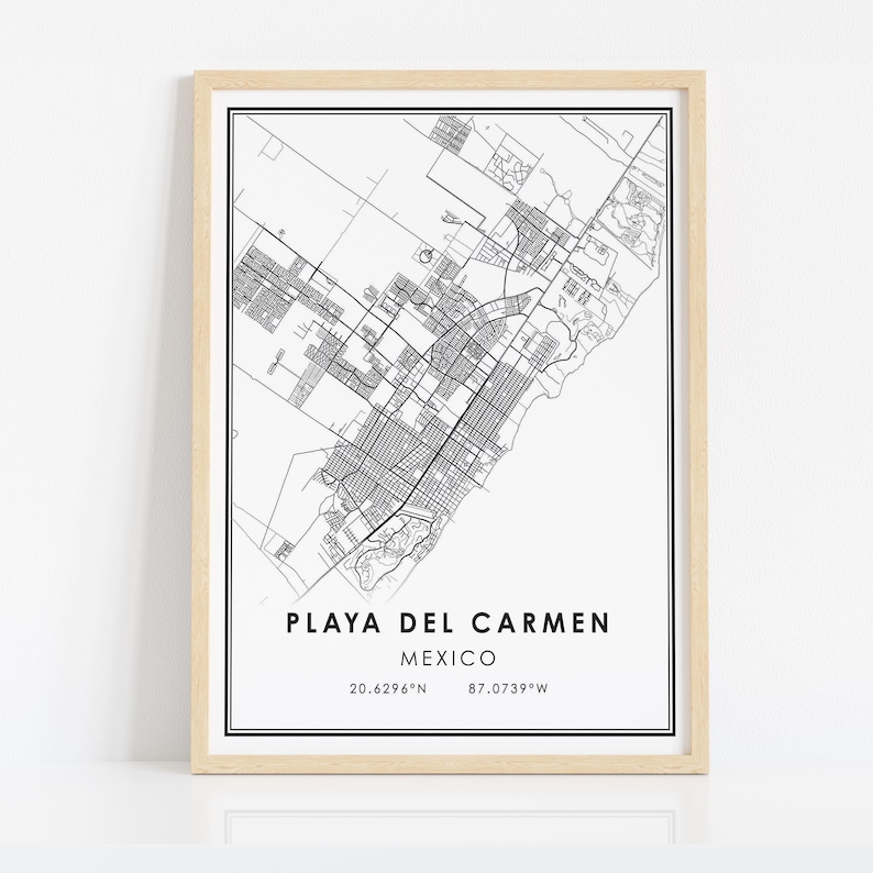 May include: A framed black and white map print of Playa del Carmen, Mexico. The map details the city's layout with streets and buildings. The text "PLAYA DEL CARMEN MEXICO" is centered at the bottom, with coordinates below.