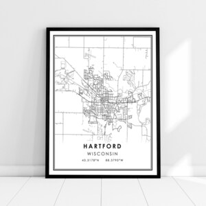 May include: Black and white line art map of Hartford, Wisconsin. The map shows the city streets and surrounding area. The text "HARTFORD WISCONSIN" and the coordinates "43.3178°N 88.3790°W" are printed below the map.