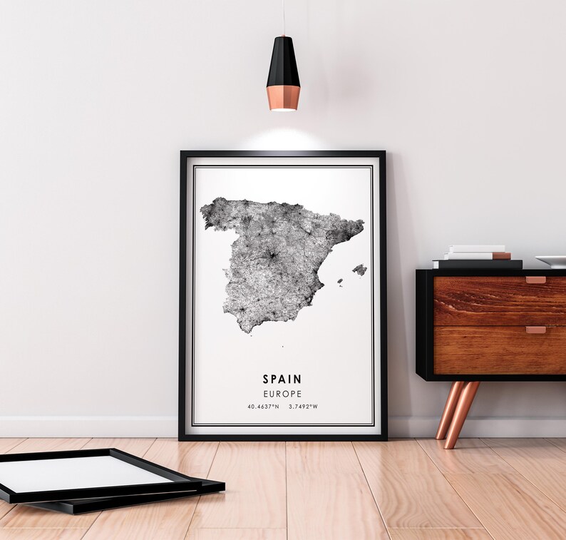May include: Black and white print of a map of Spain with the text "SPAIN EUROPE 40.4637&deg;N 3.7492&deg;W" in a black frame.