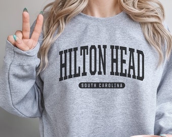 May include: Gray sweatshirt with black text that reads "Hilton Head South Carolina".