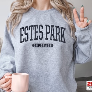May include: Gray sweatshirt with the text "ESTES PARK COLORADO" in black.