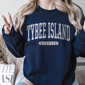 May include: A navy blue sweatshirt with the text "Tybee Island Georgia" in white lettering.