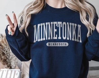May include: A navy blue sweatshirt with the text "Minnetonka, Minnesota" in white lettering.