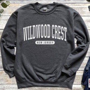 May include: A dark gray sweatshirt with white text that reads "WILDWOOD CREST NEW JERSEY".