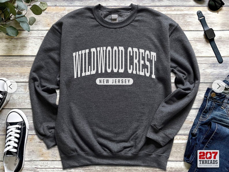 May include: A dark gray sweatshirt with white text that reads "WILDWOOD CREST NEW JERSEY".