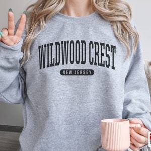 May include: Gray sweatshirt with black text that reads "Wildwood Crest, New Jersey".