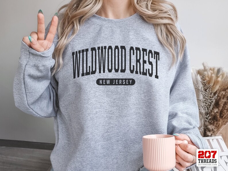 May include: Gray sweatshirt with black text that reads "Wildwood Crest, New Jersey".