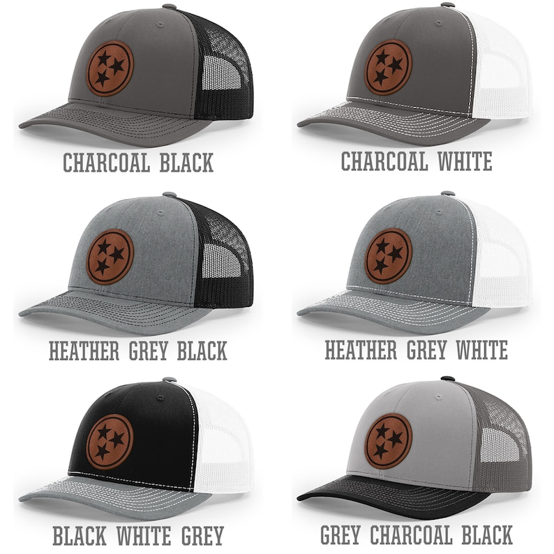 May include: Six trucker hats with a brown leather patch featuring three stars in a circle. The hats are in various color combinations of charcoal, black, white, heather grey, and grey.