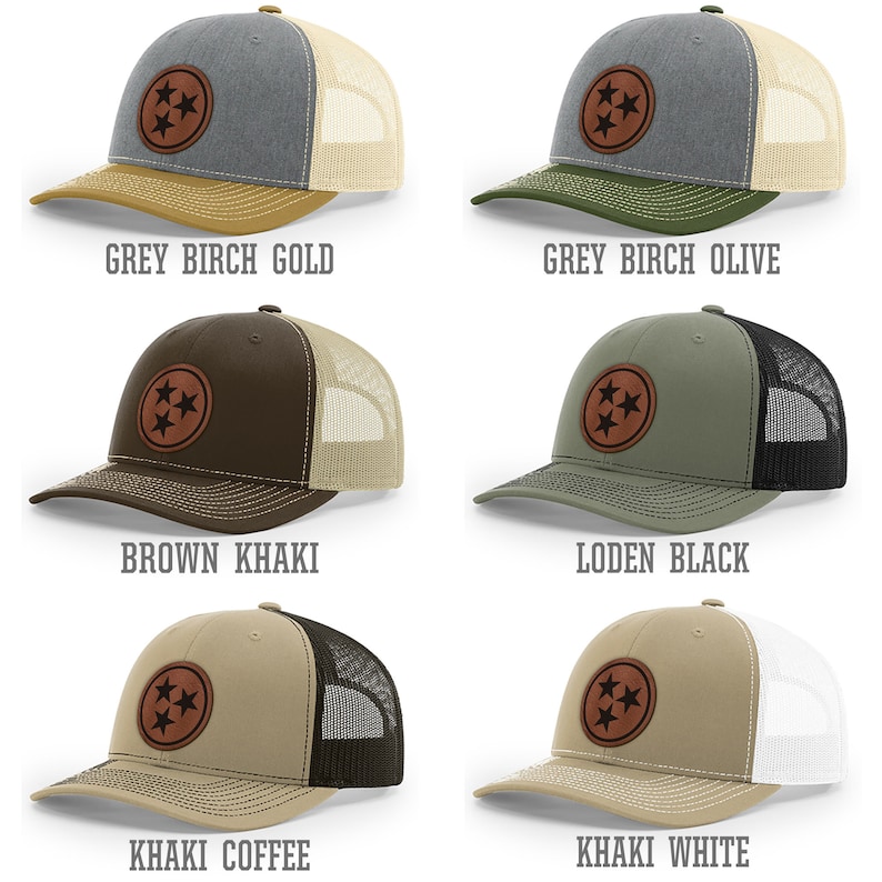 May include: Five different color combinations of a trucker hat with a brown leather patch featuring the three stars of the Tennessee state flag. The hat colors are grey birch gold, grey birch olive, brown khaki, khaki coffee, and khaki white.