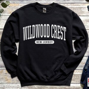 May include: Black sweatshirt with white text that reads "WILDWOOD CREST NEW JERSEY".
