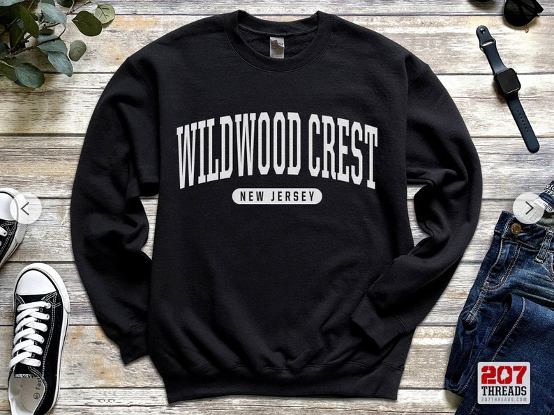 May include: Black sweatshirt with white text that reads "WILDWOOD CREST NEW JERSEY".