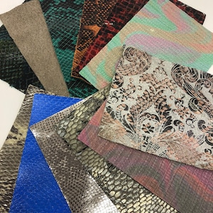 May include: Assortment of 12 different leather swatches in various colors and patterns, including snakeskin, floral, and textured designs.