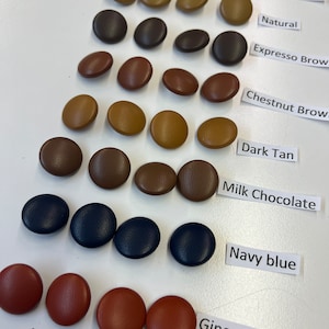 May include: Assortment of 12 round buttons in various colors, including light grey, medium grey, natural, espresso brown, chestnut brown, dark tan, milk chocolate, navy blue, and ginger spice.